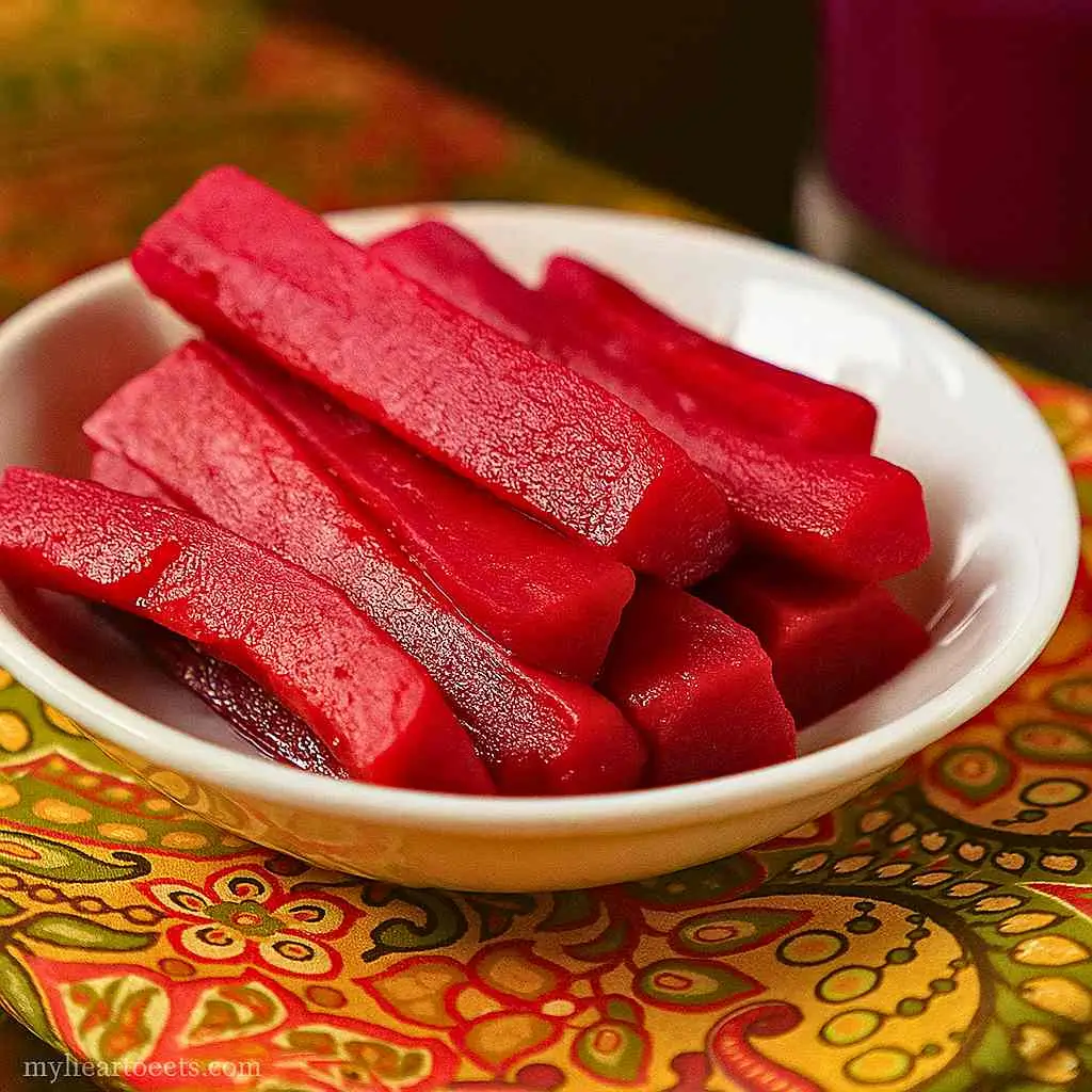 Fresh ingredients for Kanji Probiotic Drink, including carrots, beets, mustard seeds, and spices ready to be mixed.