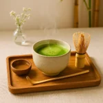 Japanese Mounjaro drink served in a traditional Japanese teacup with matcha, kombu, and ginger ingredients on a wooden table.