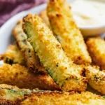 Crispy Garlic Parmesan Air Fryer Zucchini Fries served with a dipping sauce.