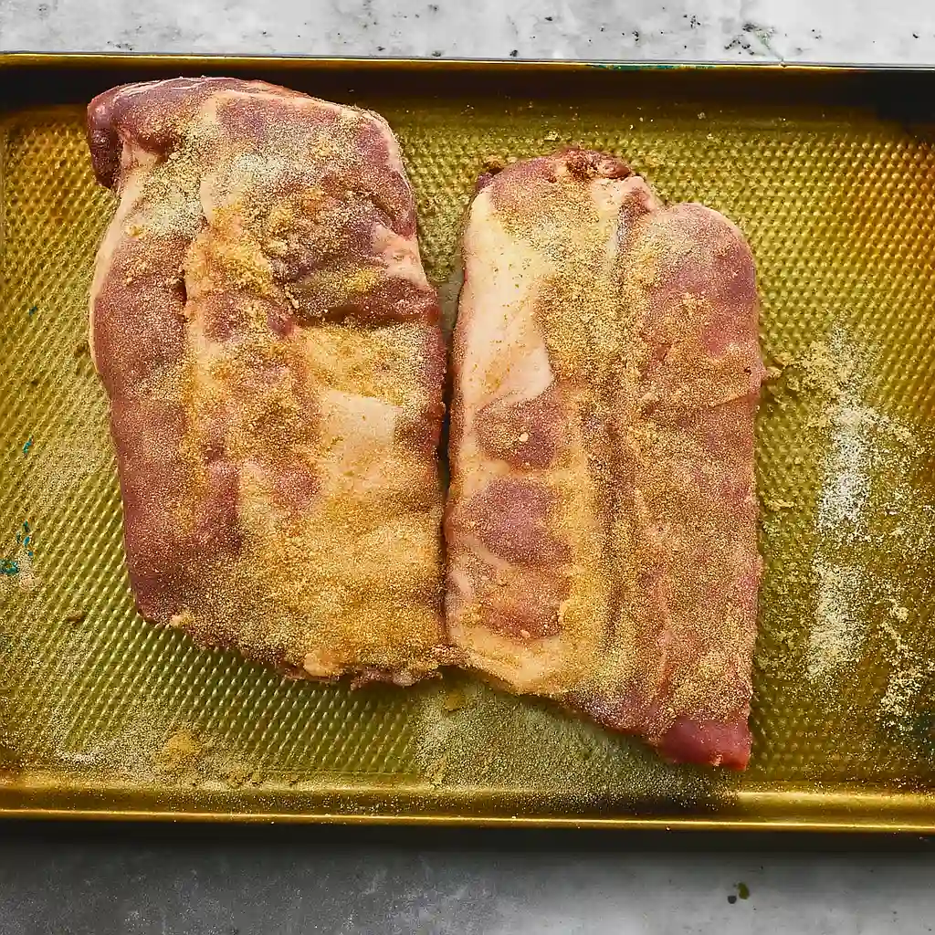 Ribs coated with seasoning mix of salt, pepper, garlic powder, and onion powder.