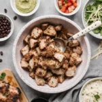 Delicious chipotle chicken recipe served with roasted vegetables, lime wedges, and guacamole