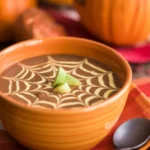 Bowl of nourishing Pumpkin Black Bean Soup, garnished with herbs and spices.