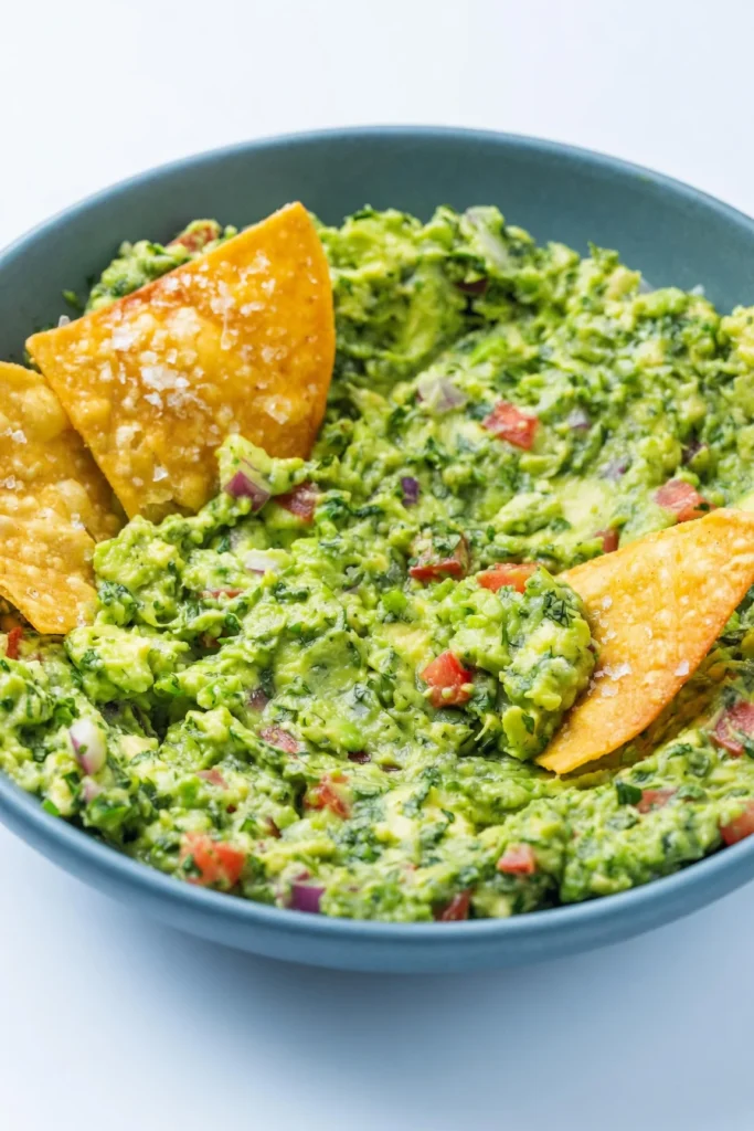 Craving the absolute best Authentic Homemade Guacamole? This simple 10-minute recipe uses fresh lime and cilantro for a perfect, restaurant-quality dip.