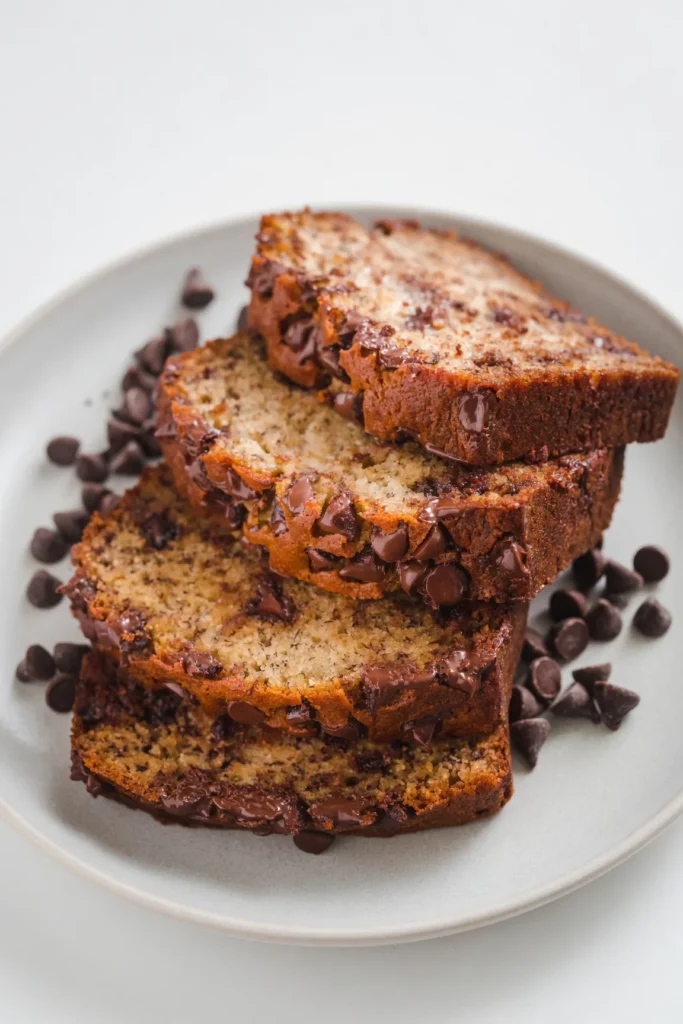 Mashing overripe bananas in a bowl with a fork for banana bread batter.