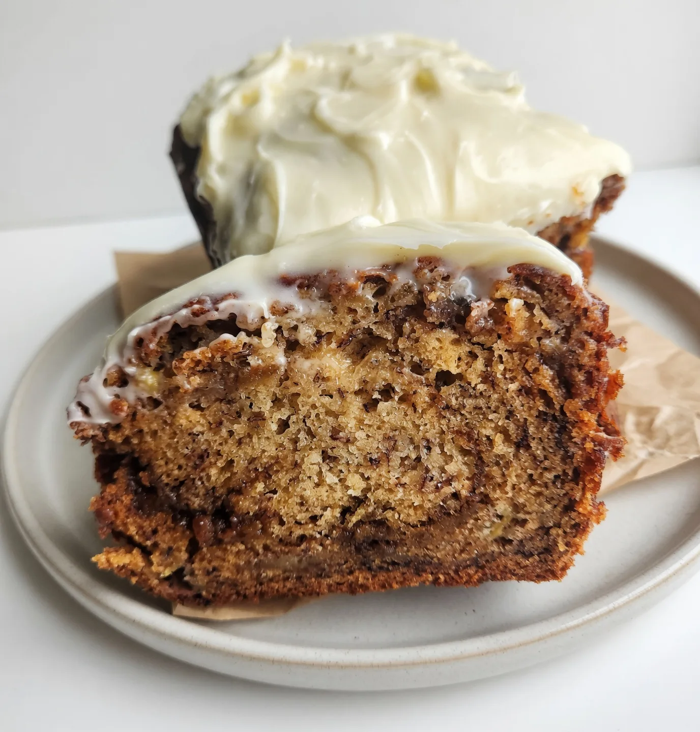 Swirling the brown sugar cinnamon mixture into the banana bread batter in a loaf pan.